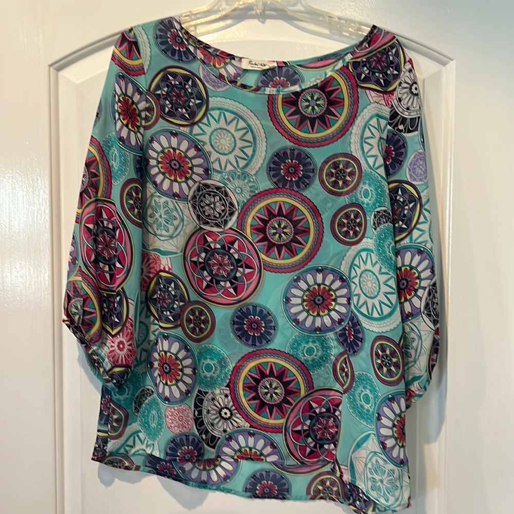 Size large top by Rachel Kata, multicolored on Turquoise background